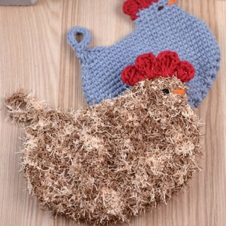 Handmade crochet scrubbie shaped like a chicken, shown in two different colors, eco-friendly alternative to disposable sponges.