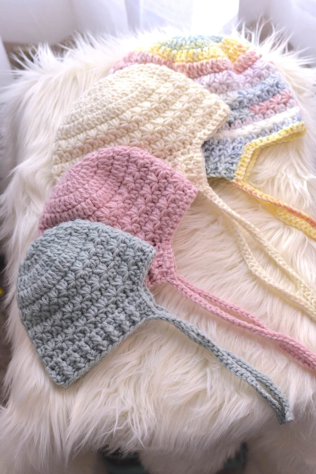Baby crochet bonnet made with star stitches and ribbed brim in soft pastel yarns