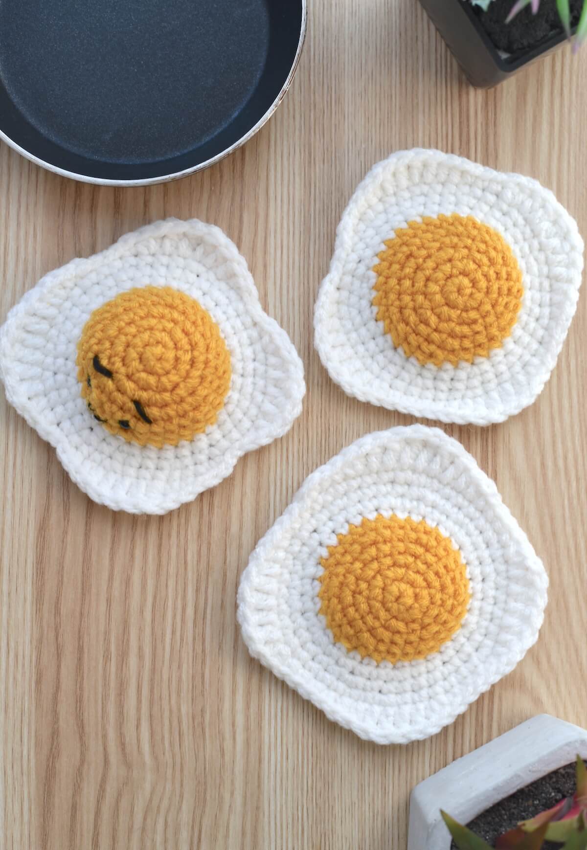 Crochet fried egg pattern sample styled as playful handmade food.