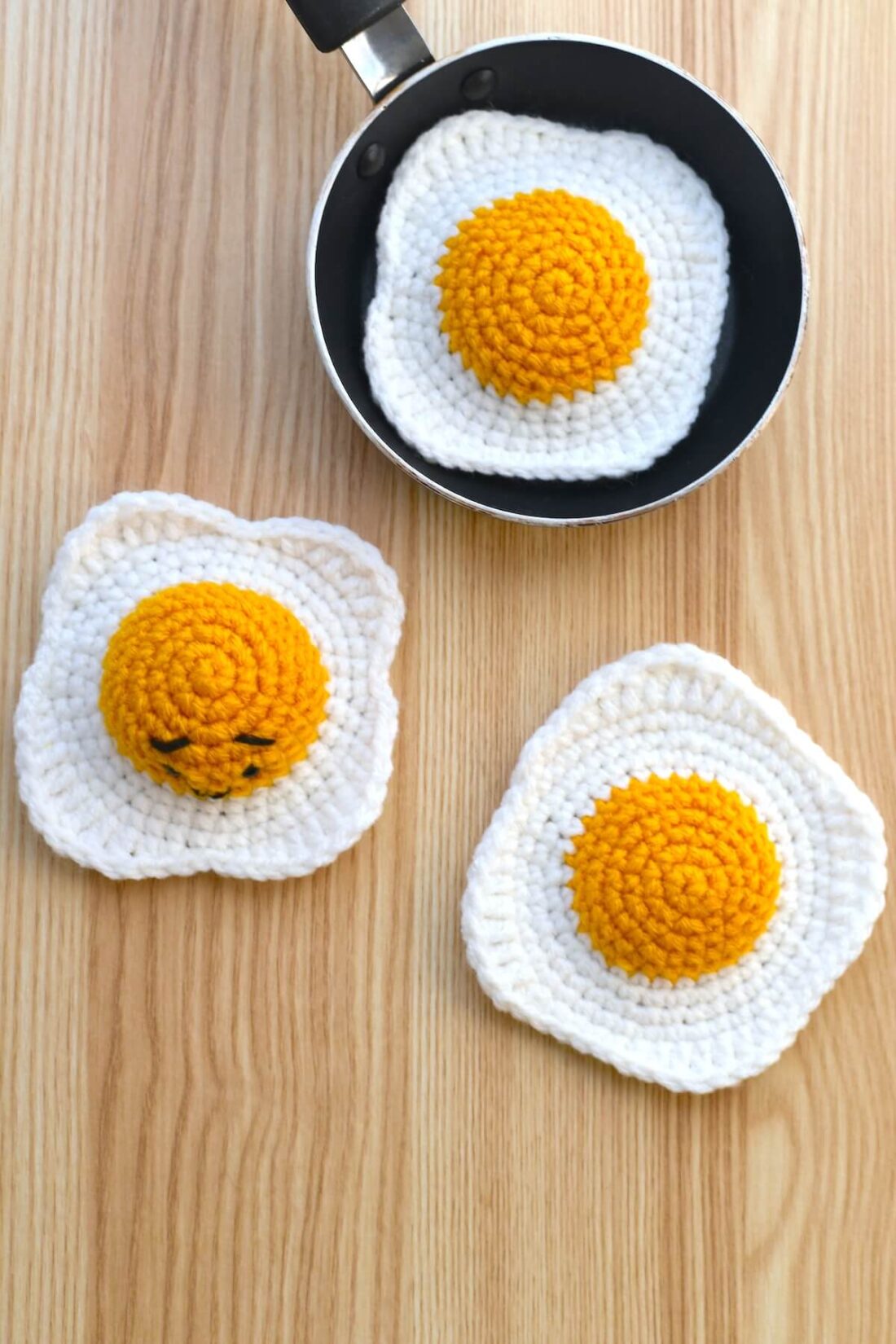 Crocheted sunny-side-up egg made with beginner-friendly stitches.
