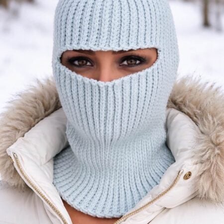 Handmade ribbed crochet balaclava pattern modeled on a mannequin in soft blue yarn.
