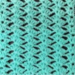 Crochet Bias Shell Stitch sample displaying an openwork lace texture with repeating shell motifs.