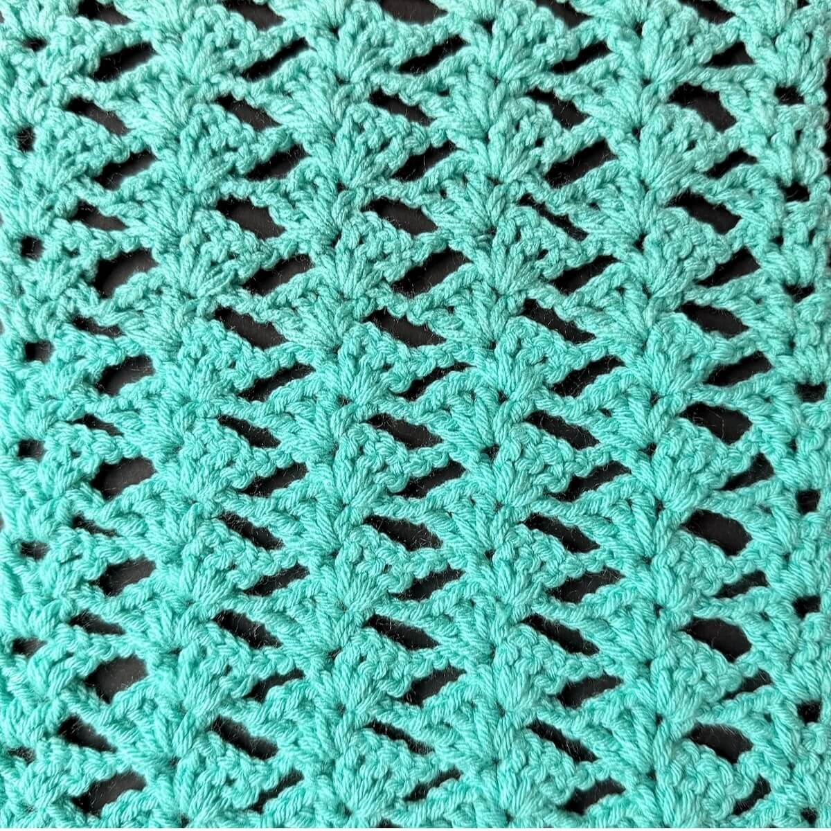 Crochet Bias Shell Stitch sample displaying an openwork lace texture with repeating shell motifs.