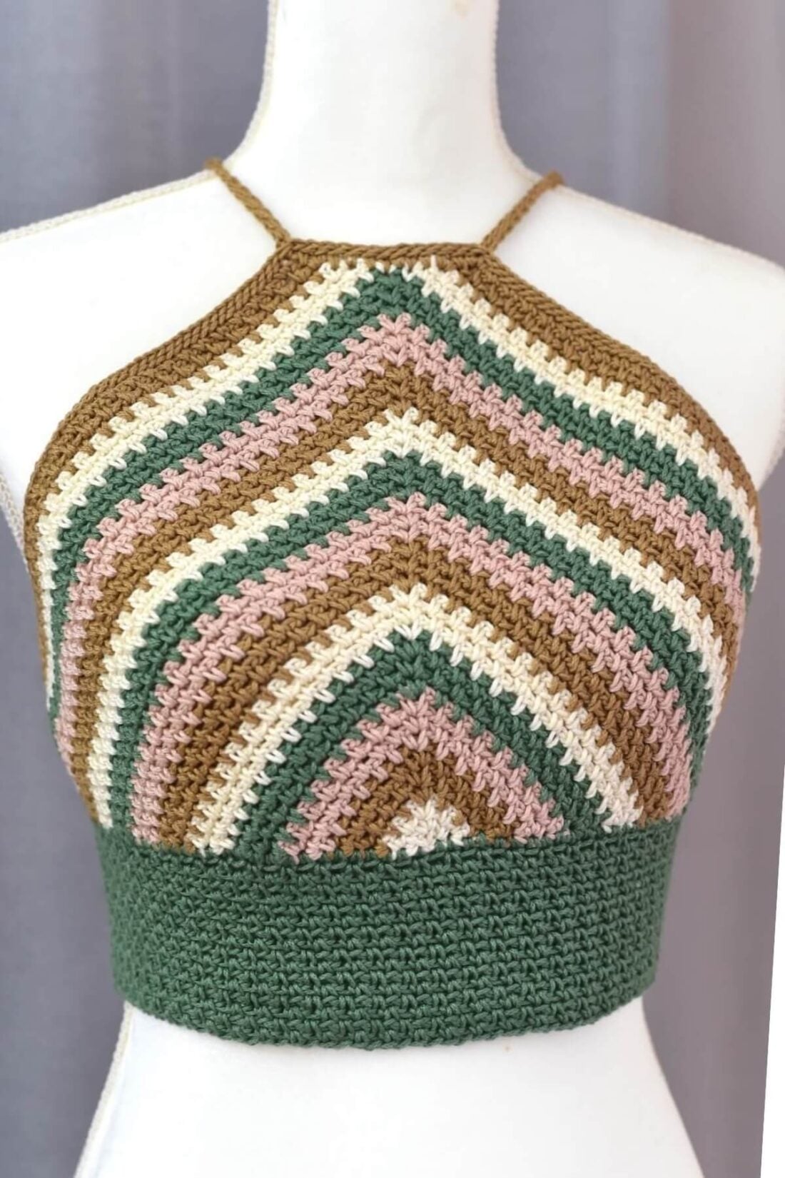 Striped crochet halter top displayed on a mannequin showing the front construction and moss stitch texture.