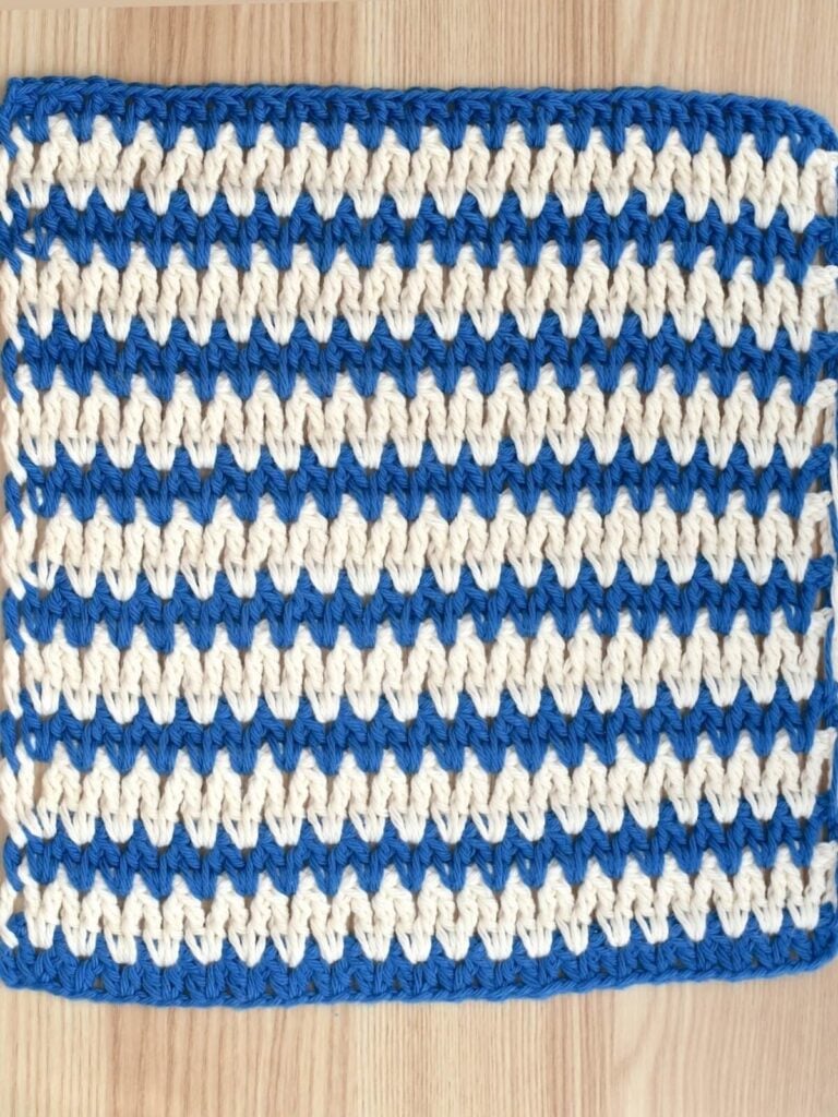 Two-color crochet V stitch swatch for stitch tutorial.