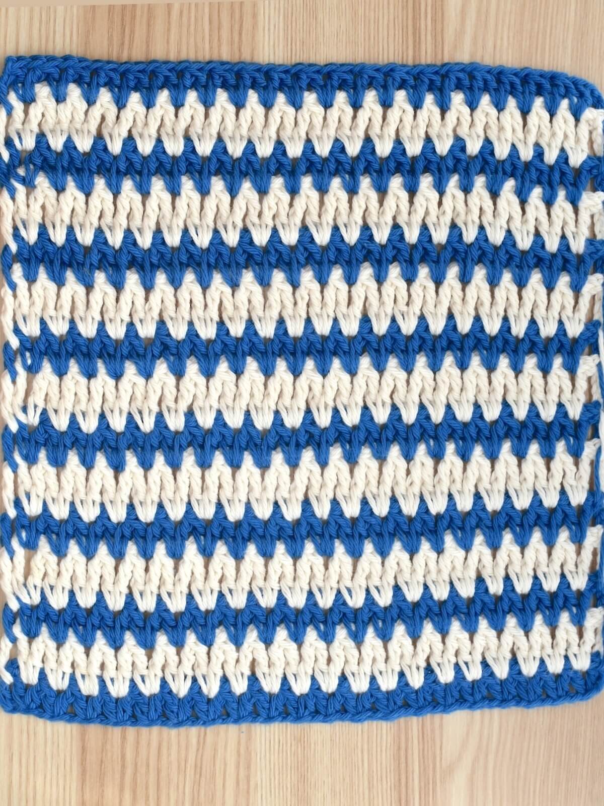 Two-color crochet V stitch swatch for stitch tutorial.