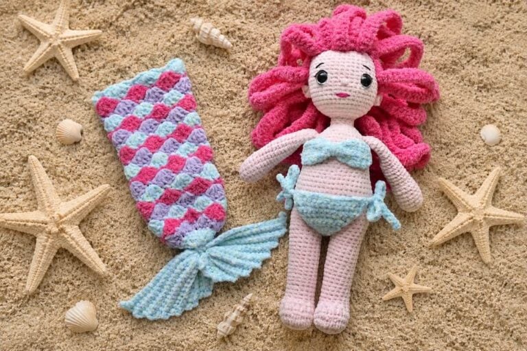 Crochet Amigurumi Mermaid doll wearing a bikini and the removable tail on the side.